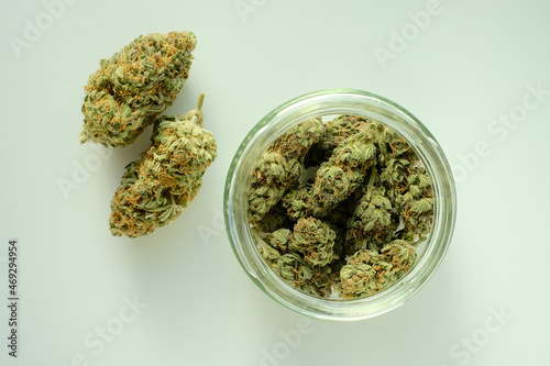 Marijuana product, trimmed buds in a jar. Medicinal cannabis stuff isolated on white background. CBD recreation, medical usage, pastime therapy.