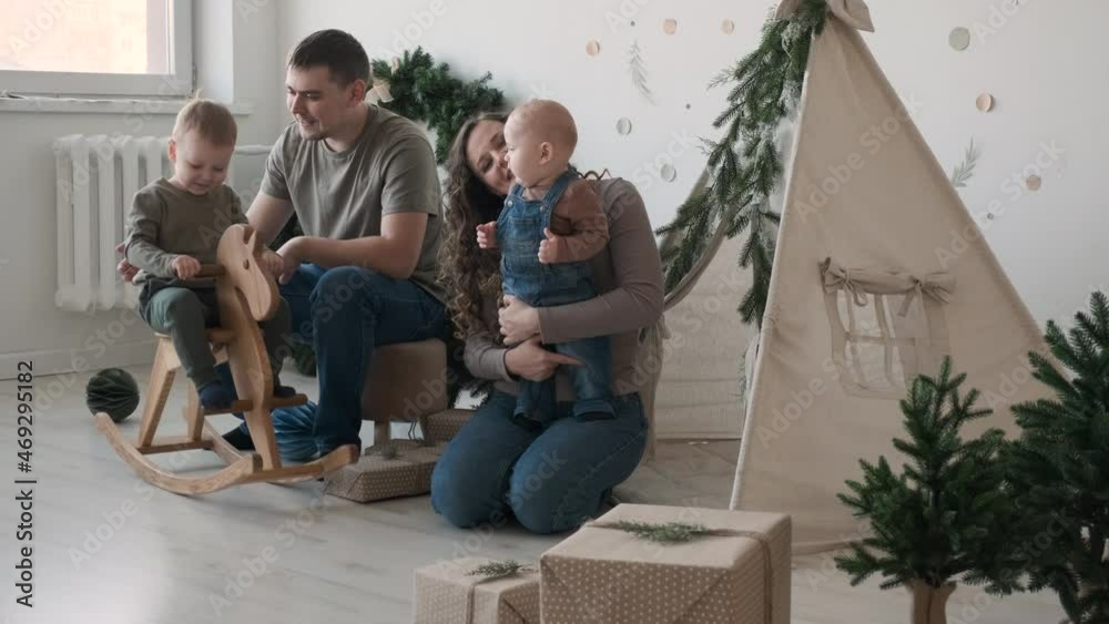 Happy Big Family Spending Christmas Day Together in the Playroom Decorated for Xmas at Home. Christmas, New Year and Winter Holiday Celebration Concept Happy Big Family Spending Christmas Day Together in the Playroom Decorated for Xmas at Home. Christmas, New Year and Winter Holiday Celebration Concept
