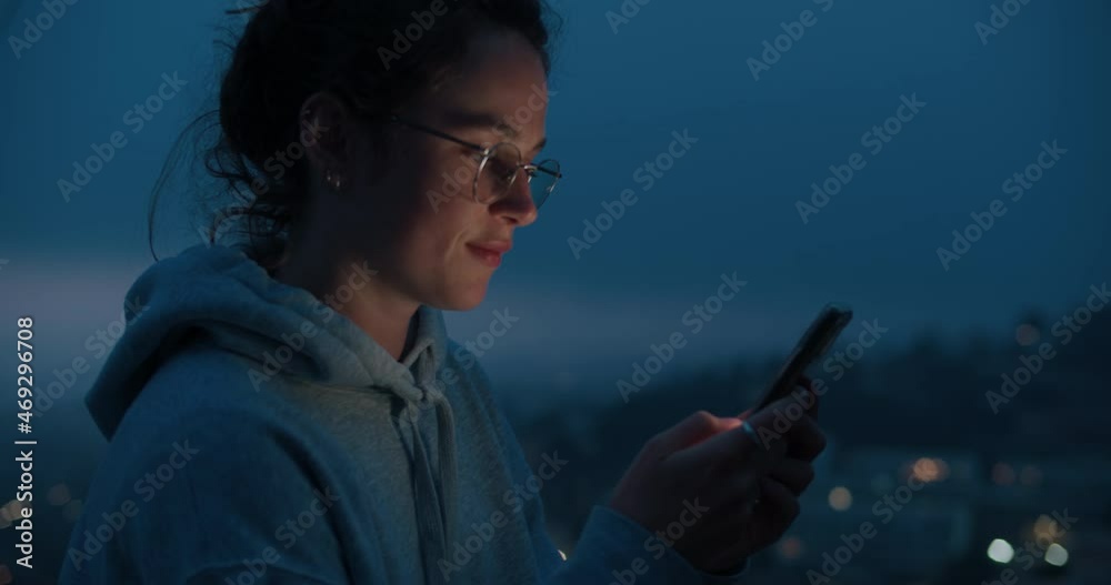 Beautiful and cute young millennial woman use smartphone and scroll through applications and social media. Technology and new generation z. Screen lit face, teenager use phone