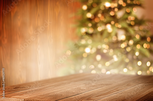 wooden table in the foreground  christmas tree in the background