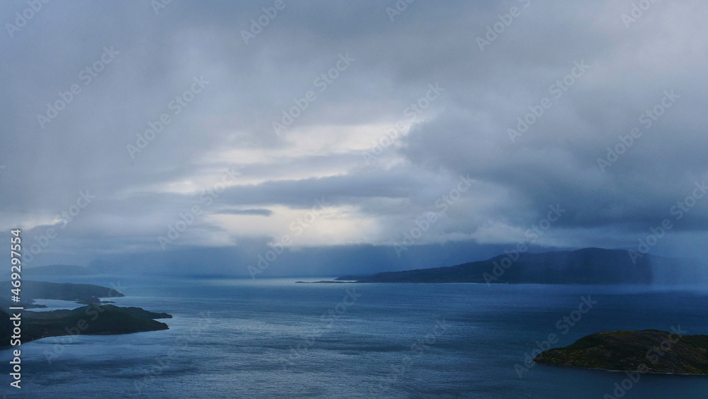 dark rain clouds over fjord in Norway