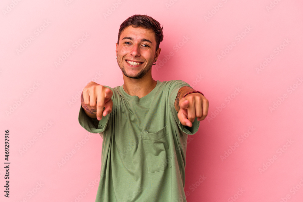 Young caucasian man with tattoos isolated on yellow background cheerful smiles pointing to front. Young caucasian man with tattoos isolated on yellow background cheerful smiles pointing to front.