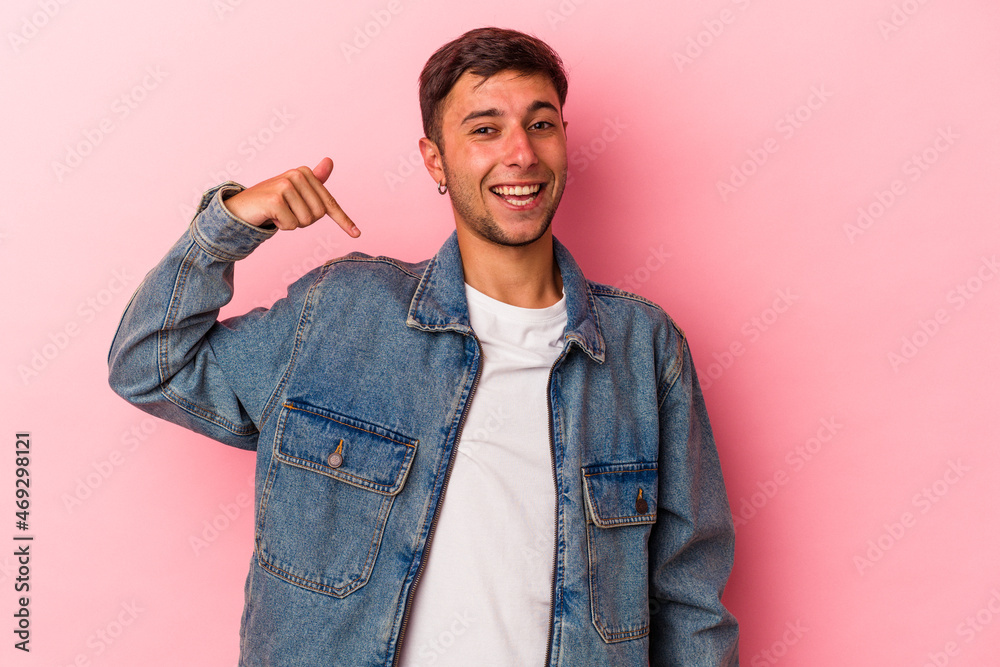 Young caucasian man with tattoos isolated on yellow background person pointing by hand to a shirt copy space, proud and confident Young caucasian man with tattoos isolated on yellow background person pointing by hand to a shirt copy space, proud and confident