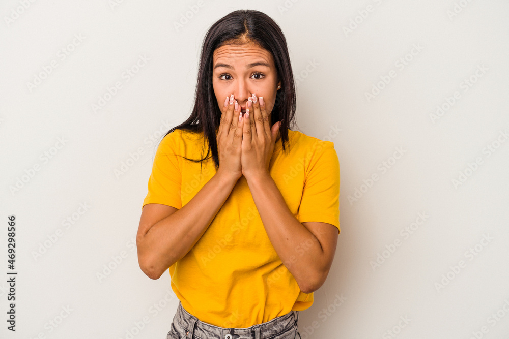Young latin woman isolated on white background covering mouth with hands looking worried. Young latin woman isolated on white background covering mouth with hands looking worried.