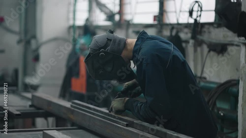 Wallpaper Mural Professional welder performs work with metal parts in factory, sparks and electricity. Industry worker banner in slow motion Torontodigital.ca