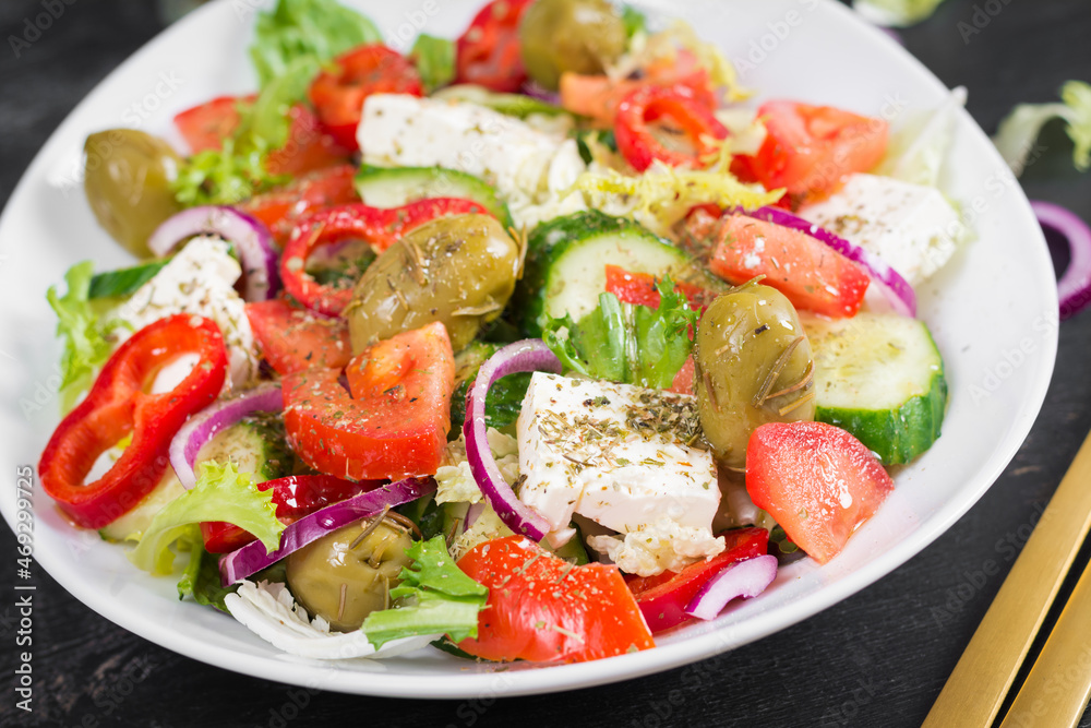 Greek salad of fresh  tomato, sweet pepper, cucumber, red onion, feta cheese and green olives. Healthy vegetarian food.