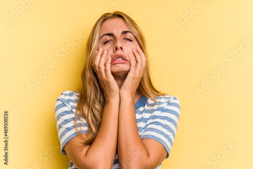 Young caucasian blonde woman isolated on yellow background  whining and crying disconsolately Fototapet