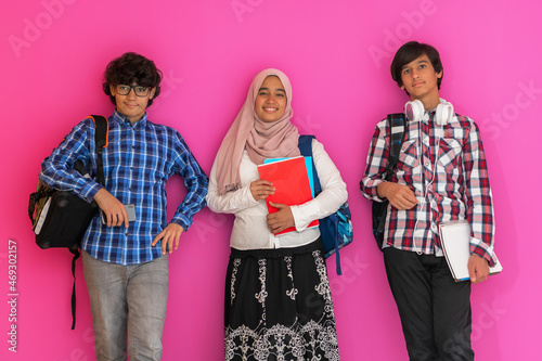 Photography A group of Arab teenagers, a student team walking forward into the future and back to school the concept of a pink background
