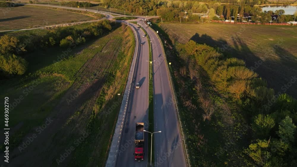 movement of cars on the highway at sunset in summer. aerial drone shooting