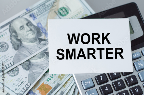 Work Smarter text on the card next to the calculator and money on the table