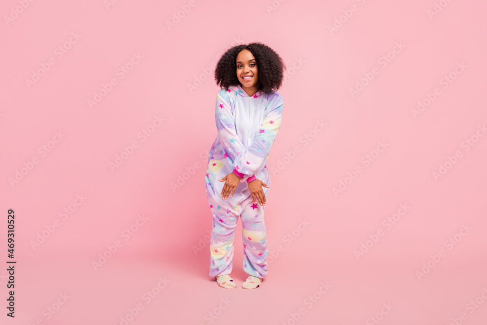 Full length photo of youth cheerful african lady good mood disco wear warm overall isolated over pink color background Full length photo of youth cheerful african lady good mood disco wear warm overall isolated over pink color background