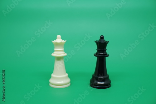 The Minister or Queen chess piece isolated on green. In the game of chess, the Queen is the King's last line of defense and has the most lethal attack ability for the opponent. 