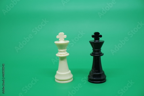 King's chess pieces are black and white facing each other. In a game of chess, King becomes the target of the opponent to be killed as a sign of the game ending in victory.