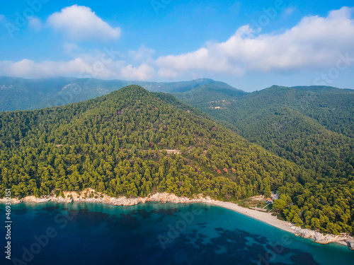 Aerial panoramic view over Milia beach in Skopelos island, against a cloudy sky in Sporades, Greece