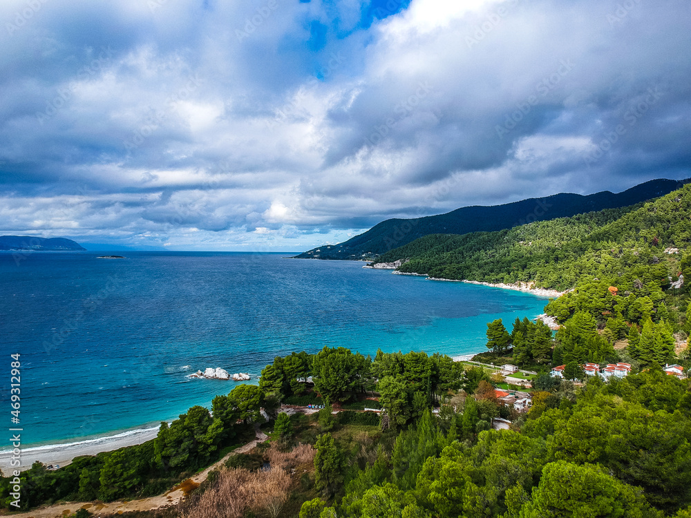 Aerial panoramic view over Milia beach in Skopelos island, against a cloudy sky in Sporades, Greece Aerial panoramic view over Milia beach in Skopelos island, against a cloudy sky in Sporades, Greece
