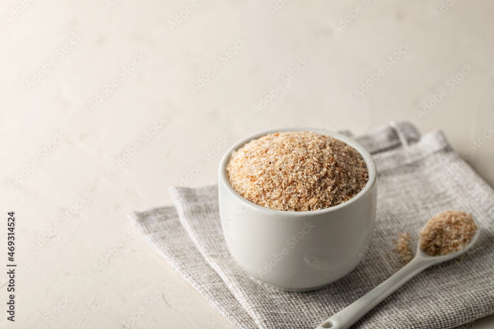 A pile of psyllium husks in a bowl on the table. Dietary supplement, superfood. Copy space A pile of psyllium husks in a bowl on the table. Dietary supplement, superfood. Copy space