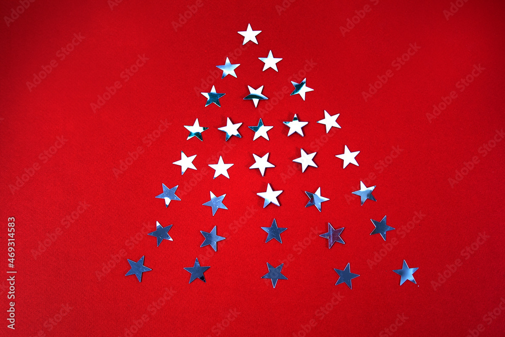 Christmas stars in the form of a Christmas tree on a red background Christmas stars in the form of a Christmas tree on a red background