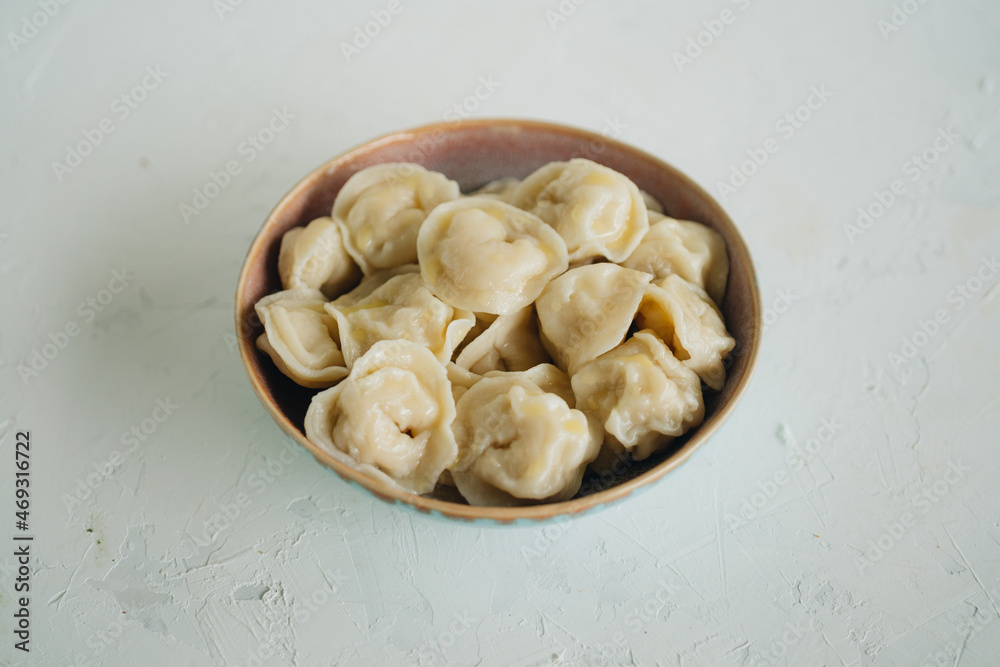 Russian dumplings with meat on white table Russian dumplings with meat on white table