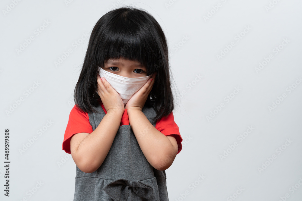 Portrait of Asian girl kid with protective face mask ready for new school year with pandemic restrictions. Concept of kid going back to school and new normal lifestyle Portrait of Asian girl kid with protective face mask ready for new school year with pandemic restrictions. Concept of kid going back to school and new normal lifestyle