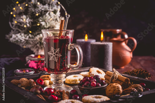 Mulled wine with cranberry and spices, Christmas cookies and candles