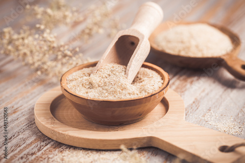 Fotografija Isabgol - heap of psyllium husk in wooden bowl on wooden table table