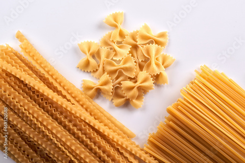 Assorted varieties of pasta wallpaper. Mix macaroni, spaghetti on white background