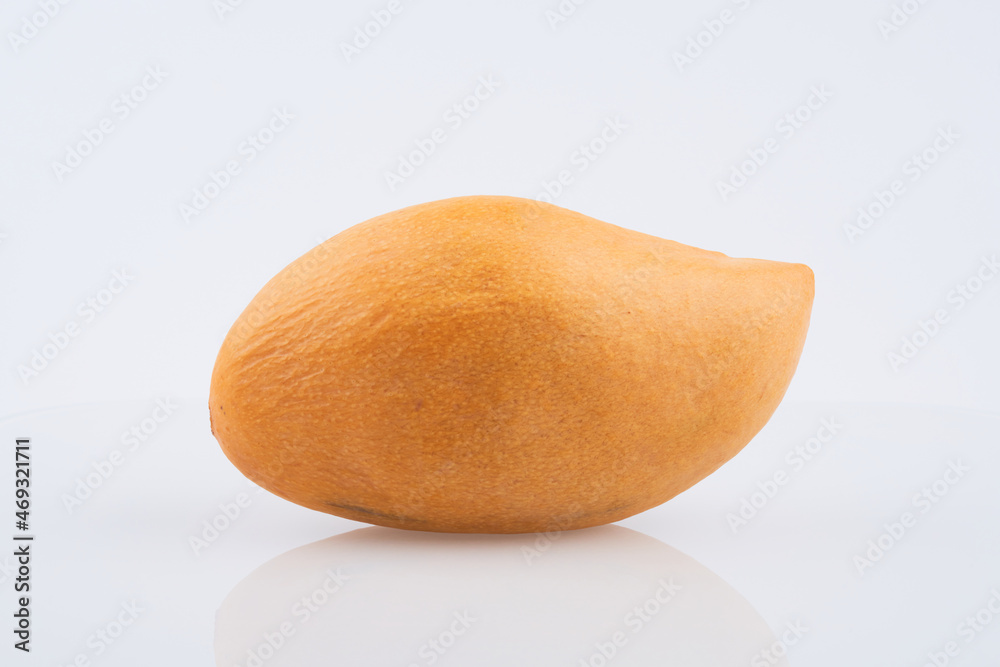 Whole orange thai mango isolated on white background, clipping path Whole orange thai mango isolated on white background, clipping path