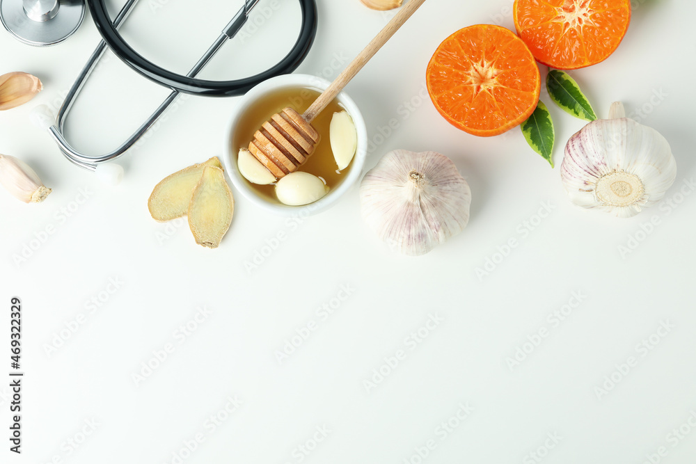 Concept of treatment colds with honey and garlic on white background Concept of treatment colds with honey and garlic on white background