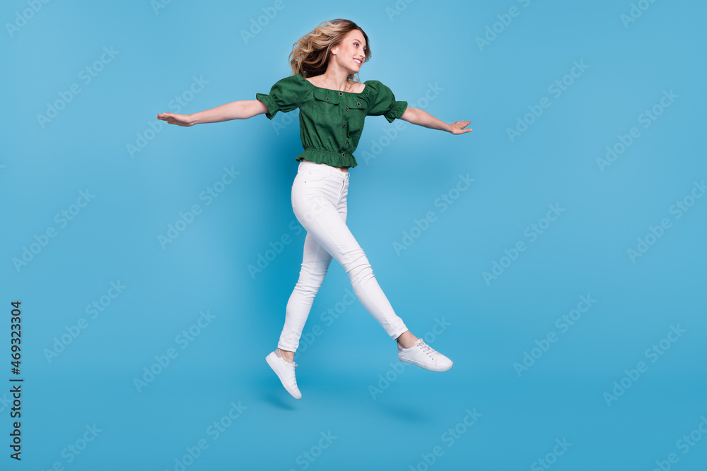 Profile photo of inspired lady jump go wear bear shoulders green blouse pants shoes isolated blue color background