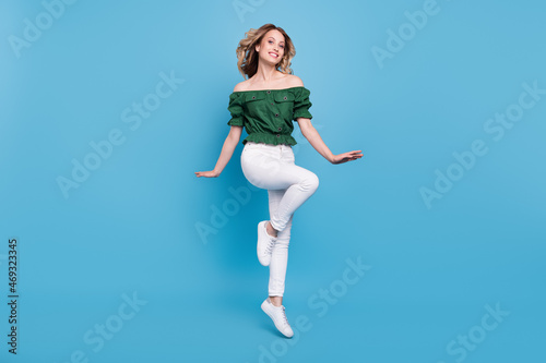 Fototapeta Naklejka Na Ścianę i Meble -  Photo of cheerful girlish lady jump enjoy weekend wear bear shoulders green blouse isolated blue color background