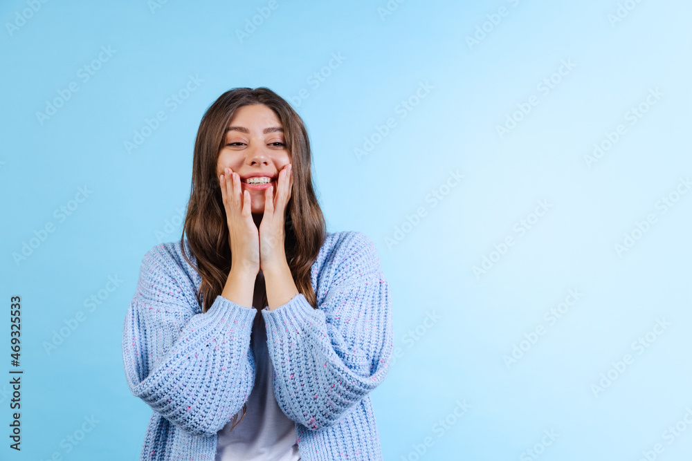 Portrait of young emotional girl posing isolated on navy color studio background in neon light. Emotions, facial expression Portrait of young emotional girl posing isolated on navy color studio background in neon light. Emotions, facial expression