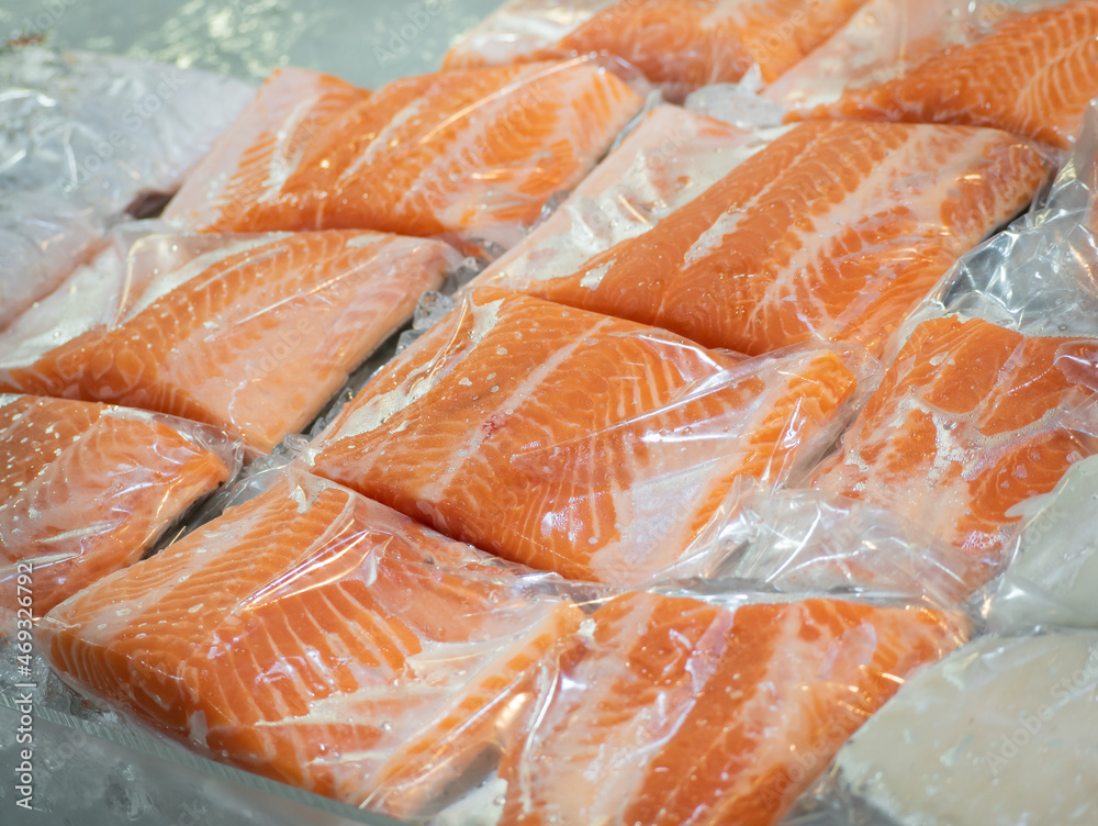 Frozen salmon fillet in plastic packing for sell in supermarket or seafood market.