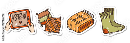 Colorful hand-drawn cold days mood stickers set with a blanket and pillow, wooly socks and the favorite series in doodle style. Cute vector collection for seasonal decoration.