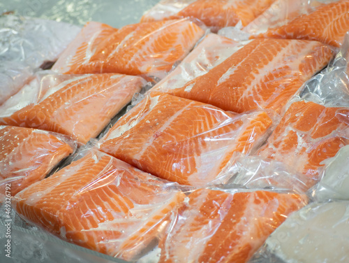 Frozen salmon fillet in plastic packing for sell in supermarket or seafood market.