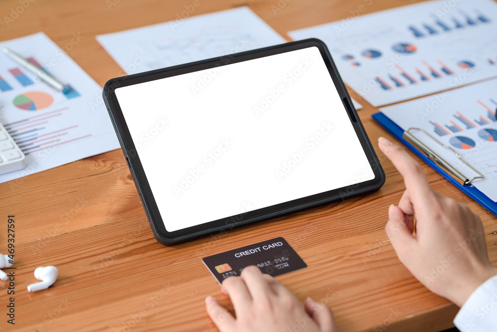 Fototapeta premium Close-up image of woman hands using tablet blank white screen and holding credit card. Online shopping concept.