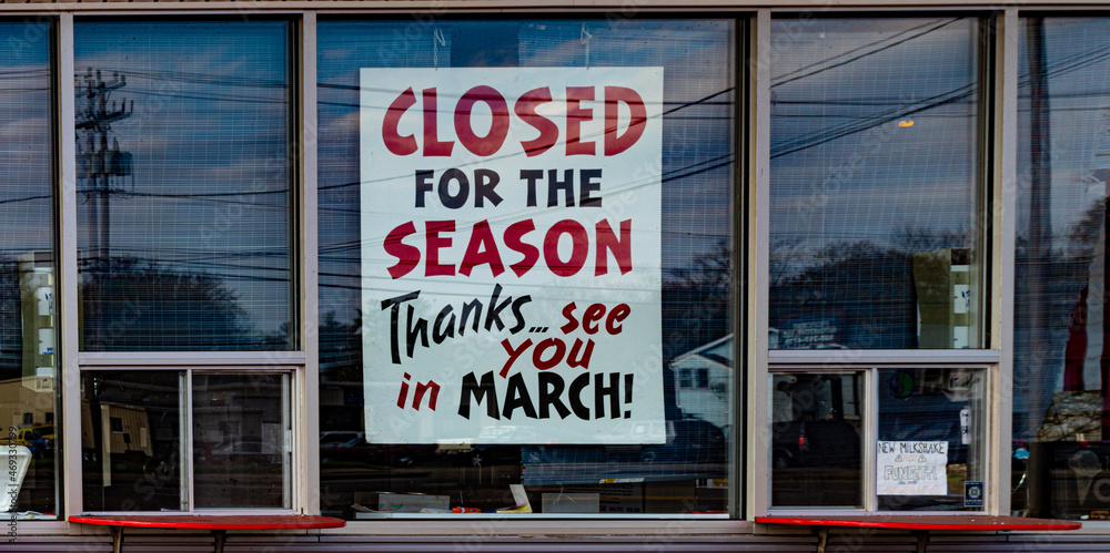 A Closed for the season sign in the window of an ice cream shop in Binghamton in Broome County in Upstate NY. A Closed for the season sign in the window of an ice cream shop in Binghamton in Broome County in Upstate NY.
