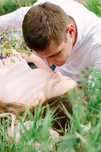 Young couple kissing laying...