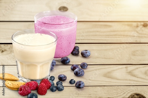 Tasty milkshake with blueberries in a glass on background. Healthy dessert
