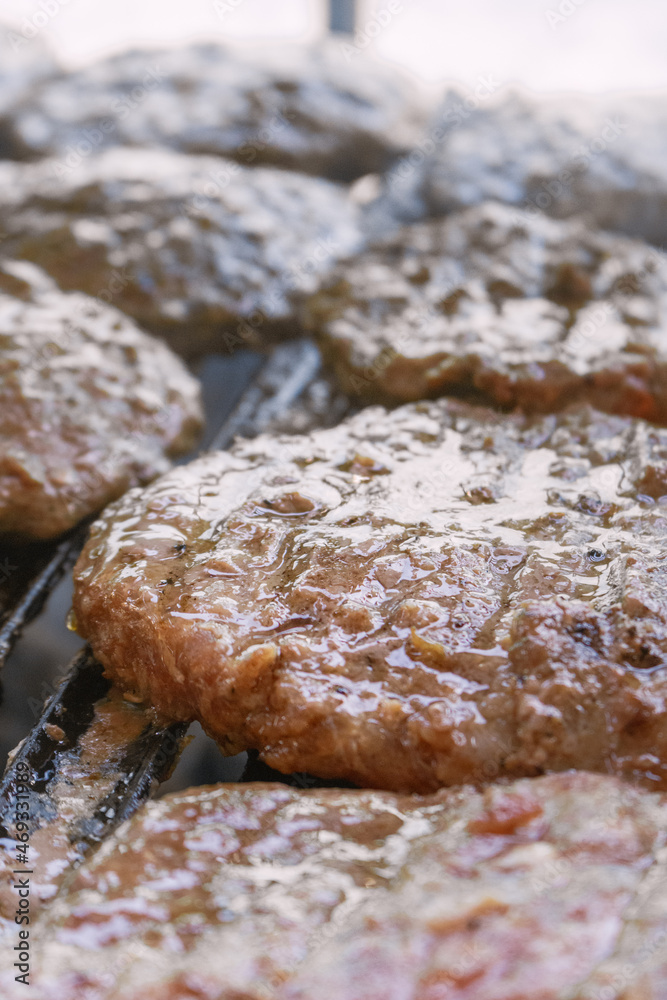 closeup of a burger meat getting baked on a grill closeup of a burger meat getting baked on a grill