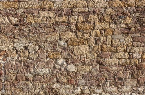 Historic stone wall. Texture of a stone wall. Old castle stone wall texture background. © MAXSHOT_PL