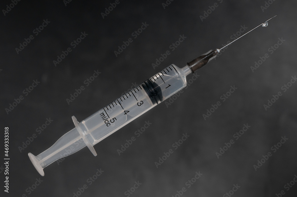 Syringe close up on black backgound