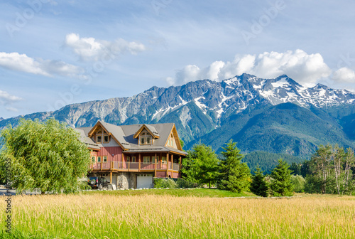 Luxury house over fantastic mountain view at sunny day in Vancouver, Canada.