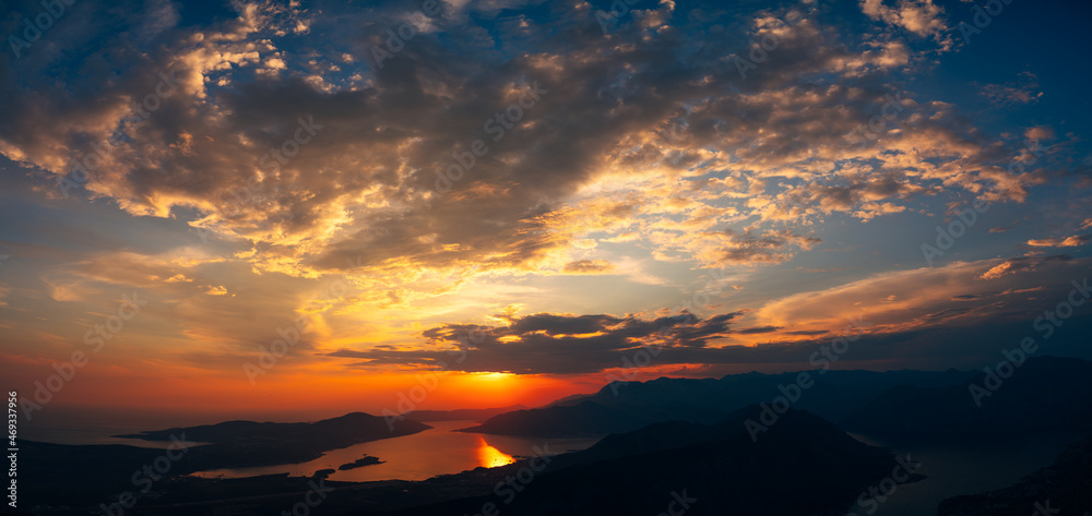 Orange rays of the sun over the horizon. Bay of Kotor, Montenegro