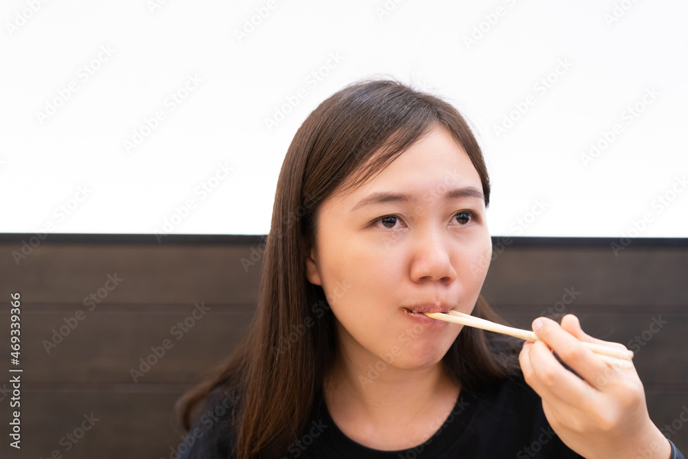 Happy Asian young woman enjoy eating Takoyaki on a dish. Happy Asian young woman enjoy eating Takoyaki on a dish.