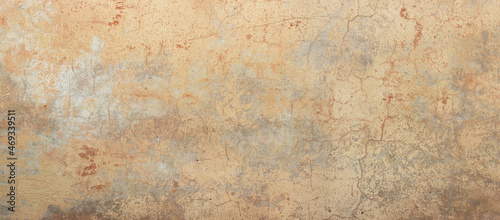  Beautiful ochre concrete wall with a lot of cracks and colorful spots 