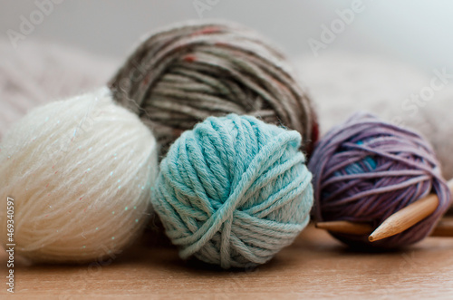 The yarn is white, blue and brown. Balls of yarn close up.