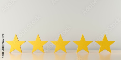 Five yellow wooden stars on table in row  five star review for best service or product quality concept