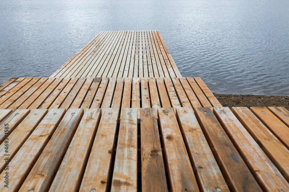 empty wooden pier on the pond. stepped pier on the water