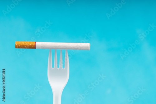the fork is stuck in the cigarette and is pointing up. on the right is a place for an inscription