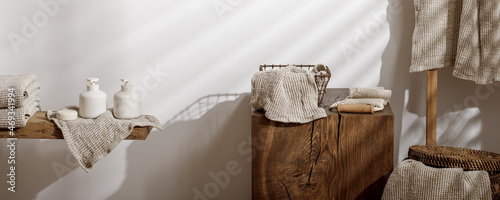 Organic waffle linen towels, bathroom zero waste accessories on solid oak stump in modern bathroom interior. Daily body care, spa and wellness zero waste bathroom concept